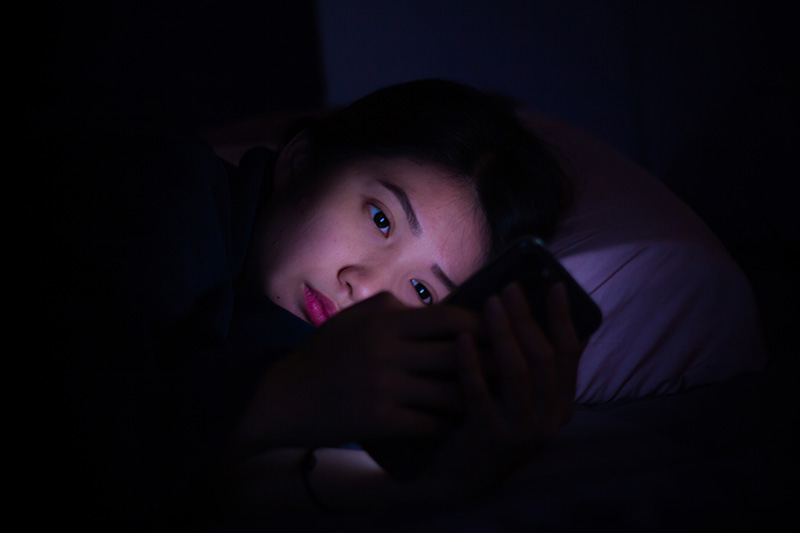 Woman using mobile phone in isolation